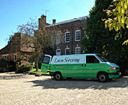 Lawn Servicing van outside house